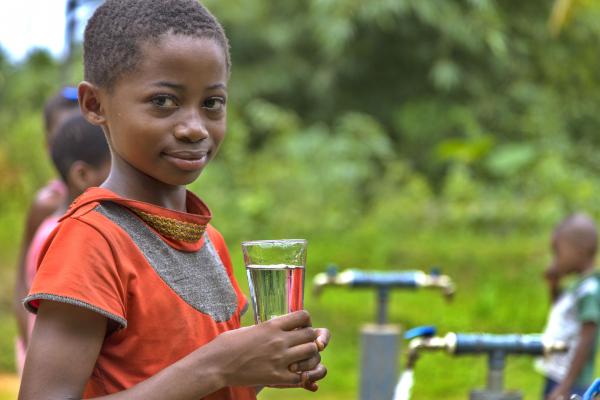 Child holding a glass of clean water